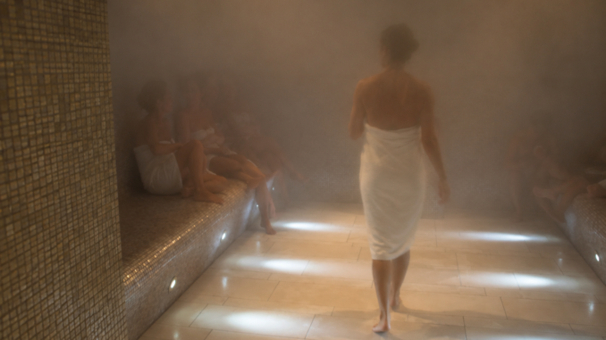 Dampfsauna in Wien mit mehreren Gästen, die in Handtücher gehüllt im warmen Dampfbad entspannen.