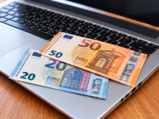 Zwei Euro-Scheine auf silbernem Laptop